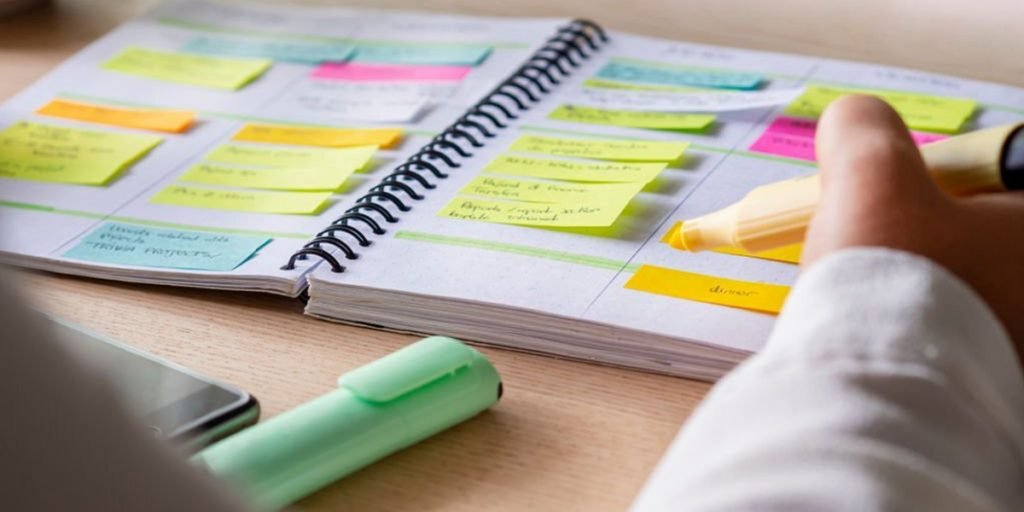 A man is marking the book with a highlighter.